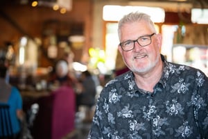 Smiling man ready to assist, representing friendly customer support